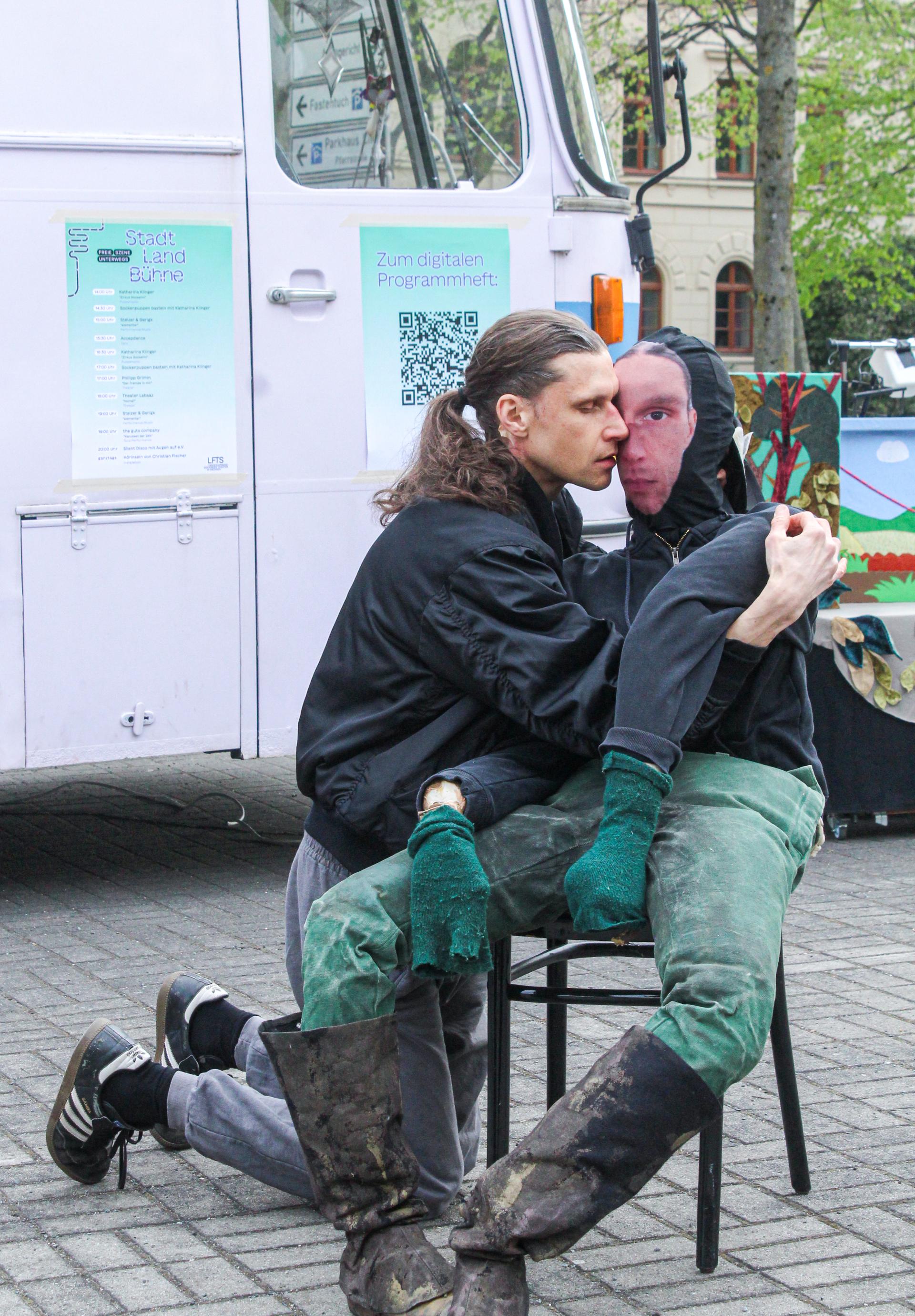 Performer with a seated doll, embracing
